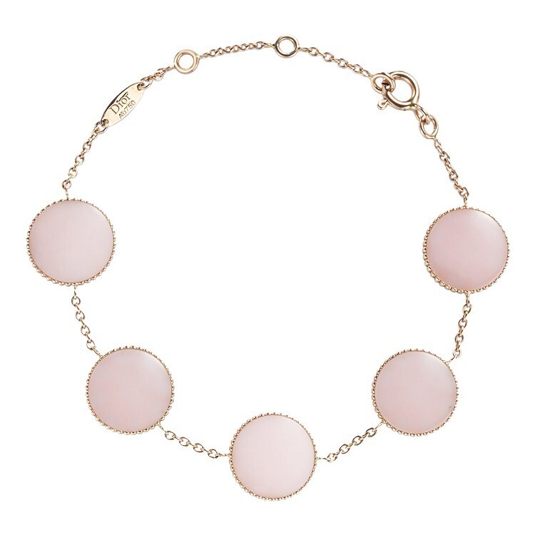 Close-up of a Dior Rose des Vents white gold bracelet featuring diamonds and vibrant pink ceramic paint