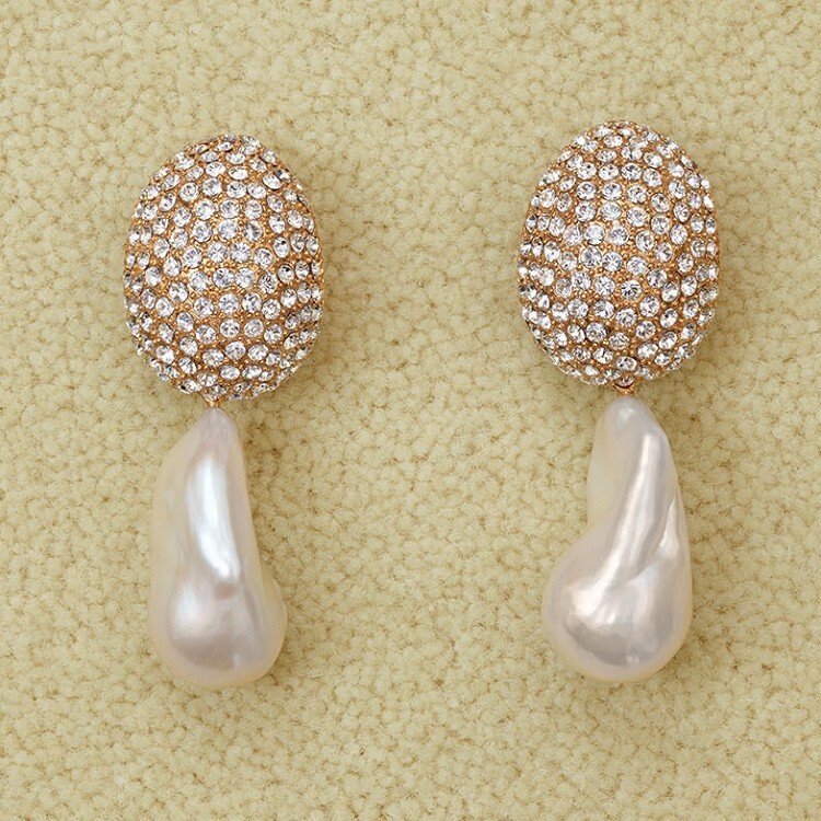 Close-up of Céline Baroque pearl earrings with pavé-set rhinestones
