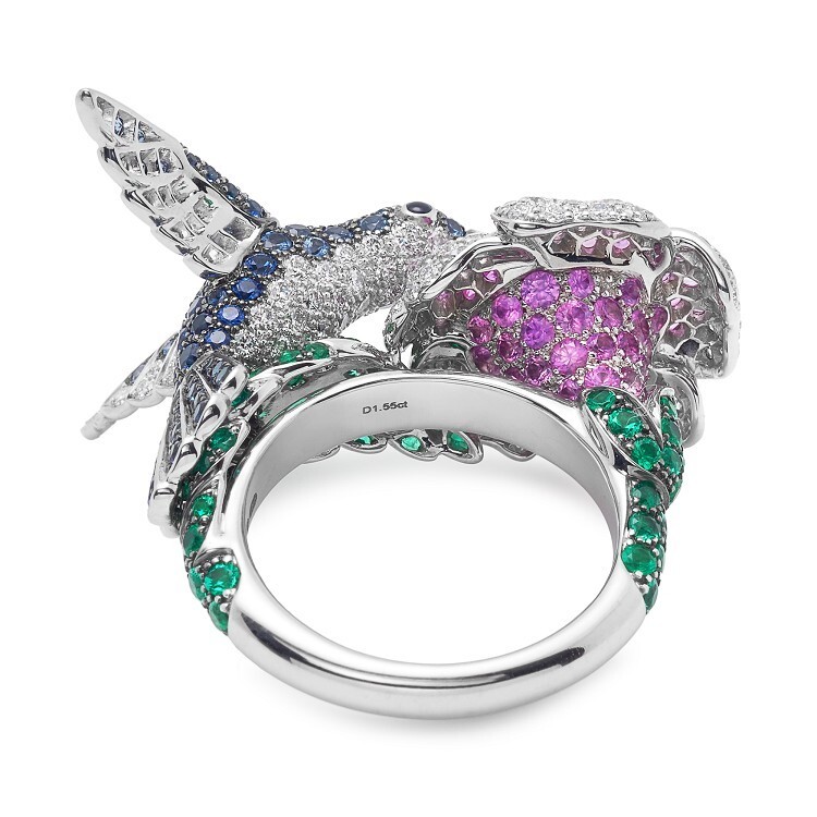 Detailed shot of the Boucheron Hopi The Hummingbird Ring, highlighting the emerald leaves and pink sapphire flower
