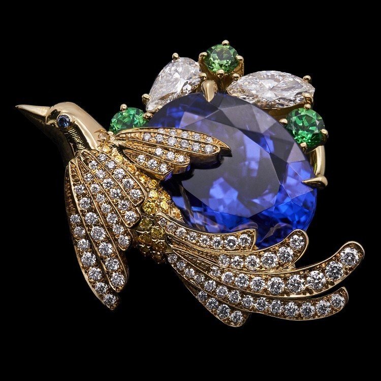 Close-up of Tiffany & Co. tanzanite and tsavorite embellishments on 'Flying Wings' earrings.