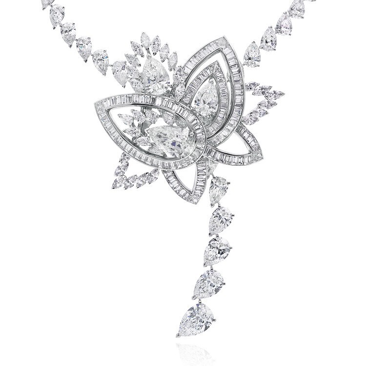 Close-up view of the De Beers Blooming Lotus necklace, highlighting the intricate diamond settings and petal design