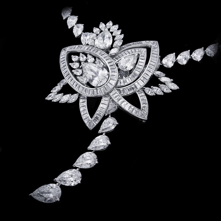 Detailed shot of the central pear-shaped diamond and surrounding baguette diamonds on the De Beers Blooming Lotus pendant