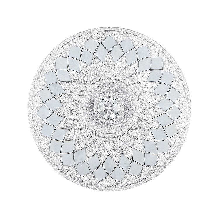 Close-up of the artistic geometric pattern on the Boucheron Rostov pendant, combining diamonds and wood inlay