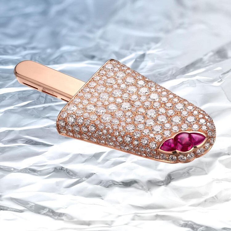 Detailed shot of the Bulgari Infanzia rose gold brooch with strawberry-like ruby accents