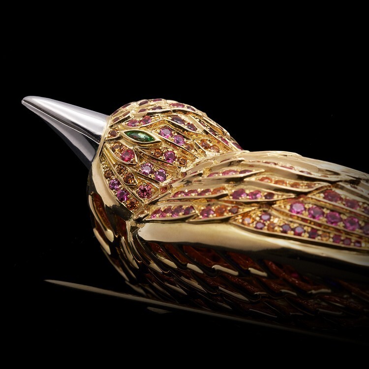 The Tiffany & Co. Feathered Cloak brooch in full, displaying its graceful form and a harmonious symphony of colored gemstones and precious metals.