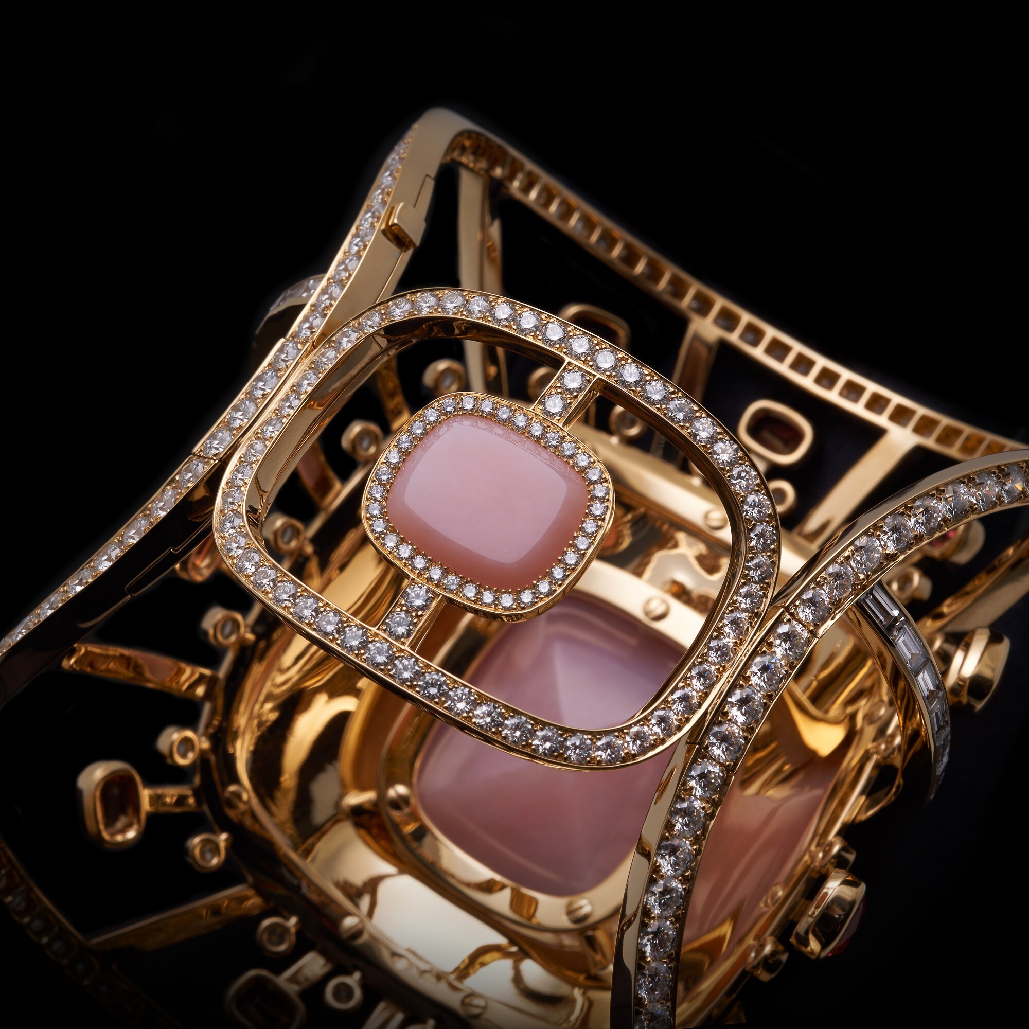 Close-up view of the Hermès Attelage Céleste gold ring, emphasizing the exquisite detail of the gemstones and gold work.
