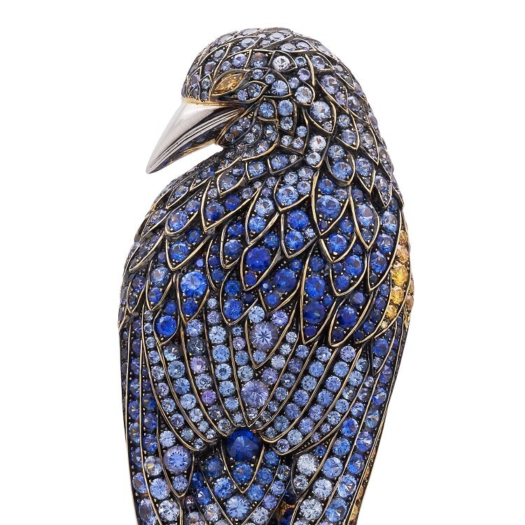 Close-up of the Tiffany Feathered Cloak Brooch, highlighting the marquise-shaped yellow sapphire eye and intricately set round-cut sapphires and yellow diamonds.