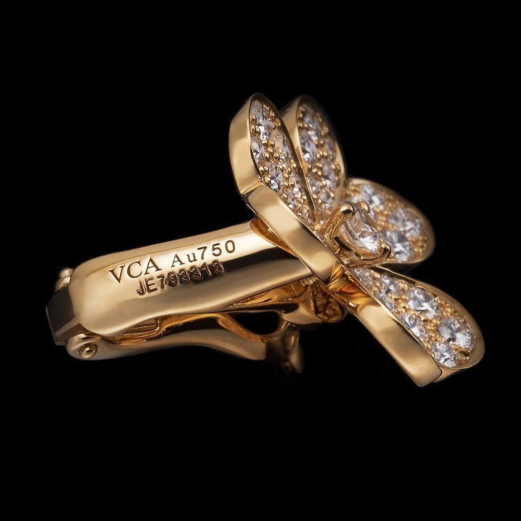 Collection display of Van Cleef & Arpels Frivole ring and earrings on a white background
