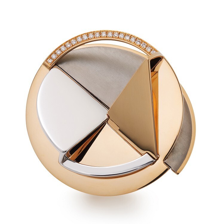 Close-up view of the Hermès Trajectoire ring, highlighting the intricate rose gold, titanium, and silver construction.