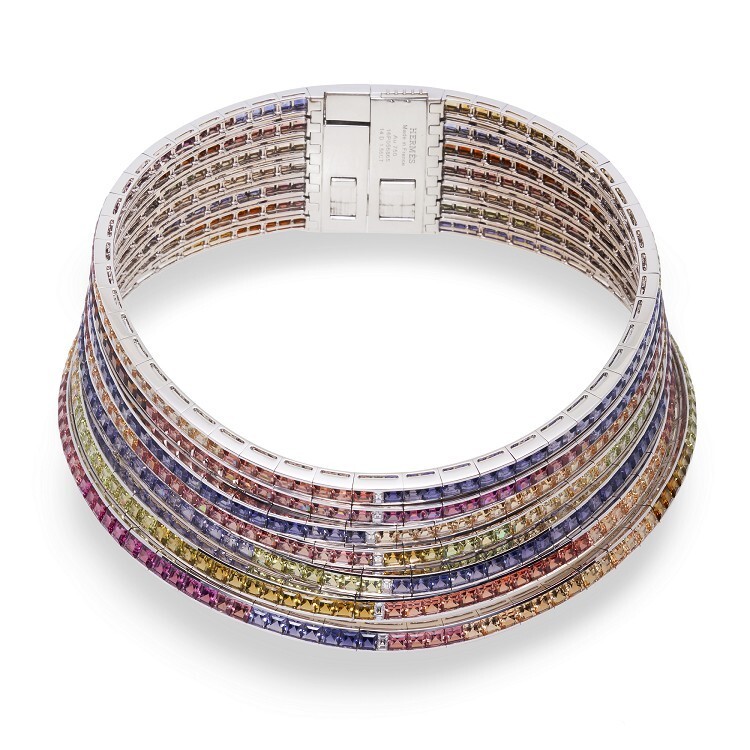 Close-up of the Hermès Feux du Ciel necklace, featuring vibrant pink tourmalines, red garnets, and orange topaz.