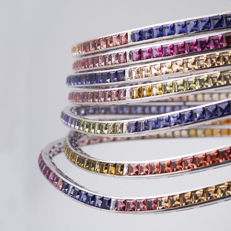 Angled view of the Hermès Feux du Ciel high jewelry piece, emphasizing the brilliance of its colored gemstones and diamond accents.