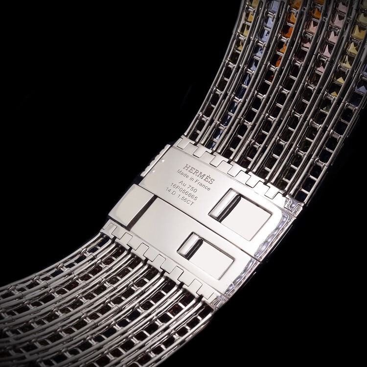 Glimmering surface of the Hermès Feux du Ciel collar, reflecting light off its diverse gemstone array.