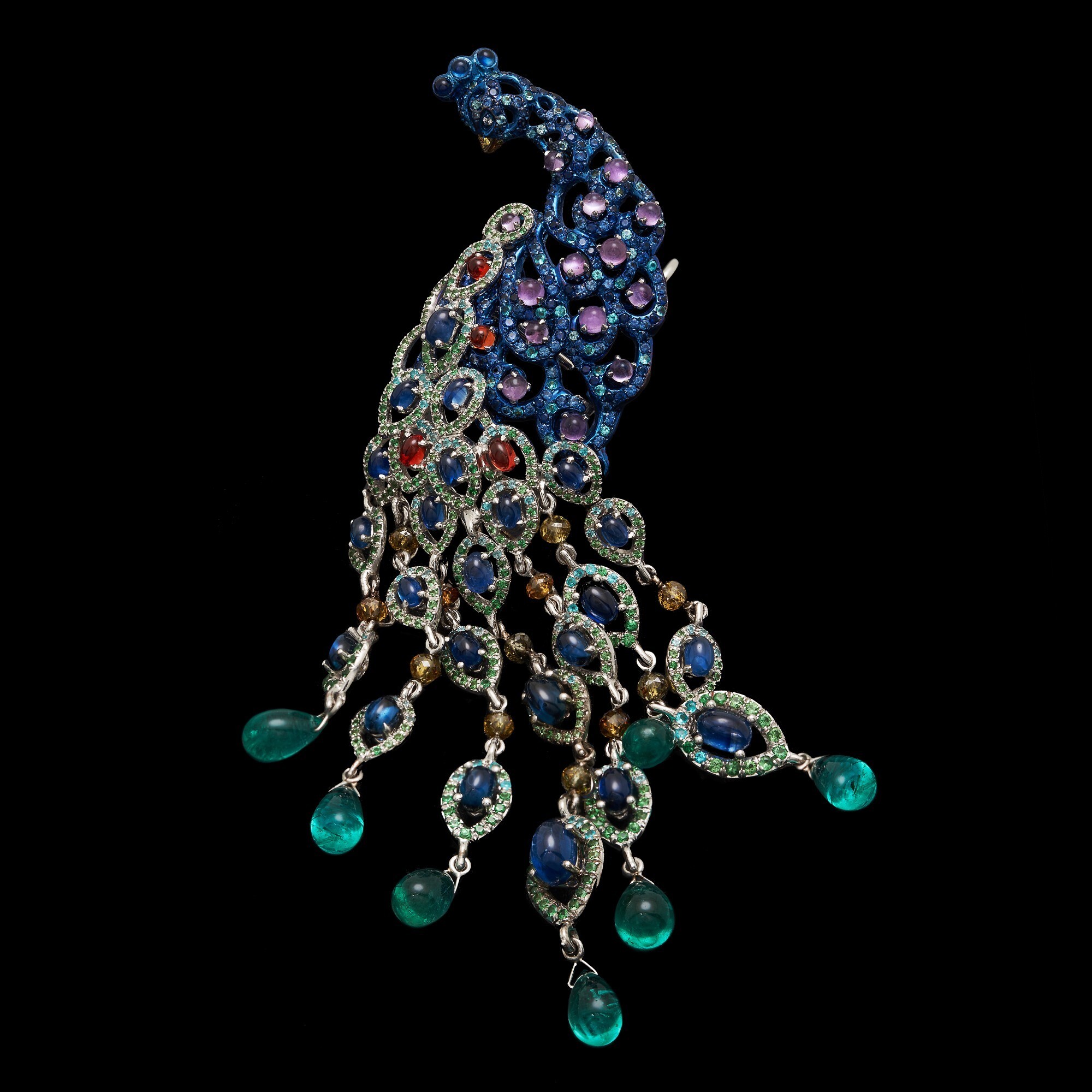 Detail shot of Chopard Animal World Peacock earrings featuring tsavorites, garnets, and tourmaline accents