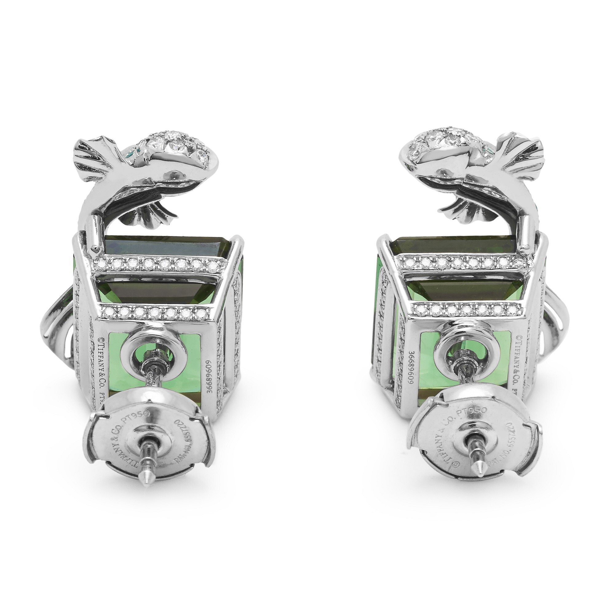 Angled view of Tiffany & Co. "The Art of Transformation" goldfish earrings, highlighting the vibrant green tourmalines and platinum setting.