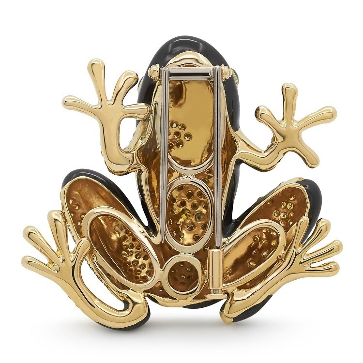 Close-up of the Tiffany & Co. tree frog brooch, showing its articulated toes, polished gold details, and intricate gemstone setting.