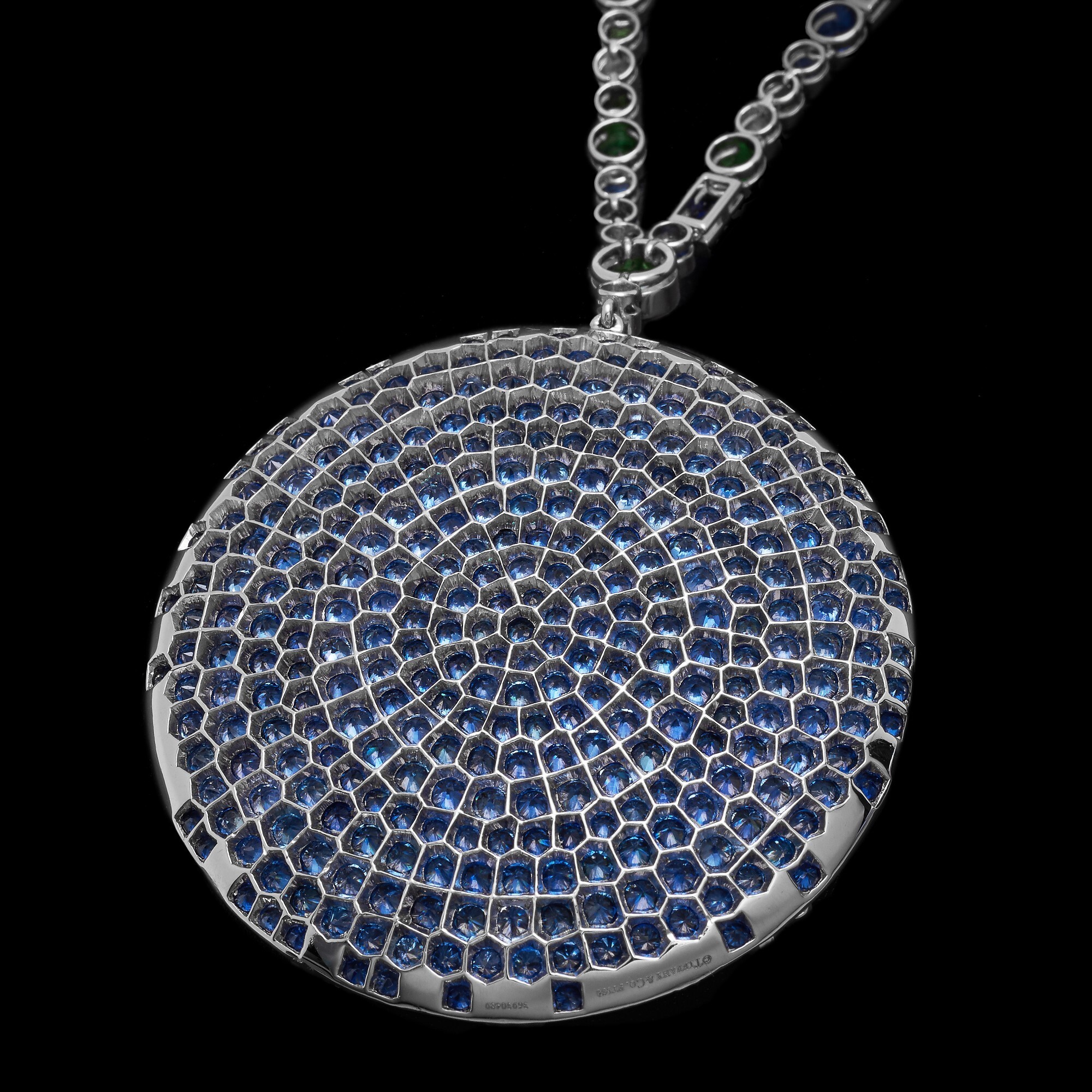 A Tiffany & Co. Blue Book pendant necklace with a focus on the sapphire-adorned ocean floor, hinting at the depth and richness of gemstones.