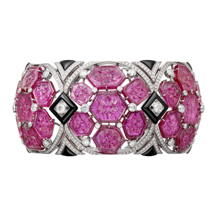 Close-up of the Cartier Étourdissant Sindura bracelet, showcasing the hexagonal arrangement of engraved rubies and sparkling diamonds.