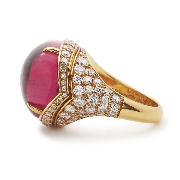 Detailed view of the Bulgari Mediterranean Eden ring's cabochon rubellite, highlighting its vibrant red hue and smooth dome shape