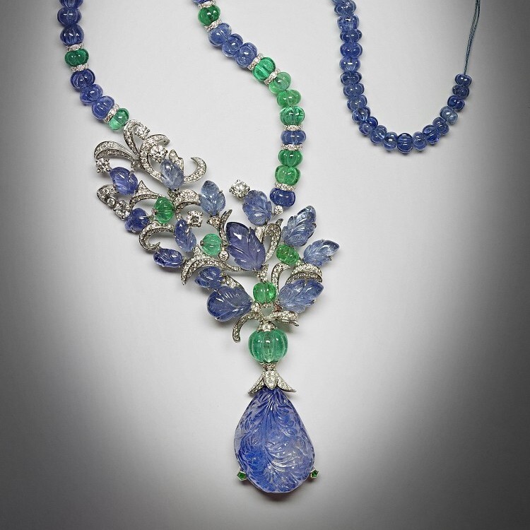 Close-up view of the Cartier 'Fruit Tips' sapphire necklace showcasing intricate carving on the sapphire pendant and diamond embellishments.