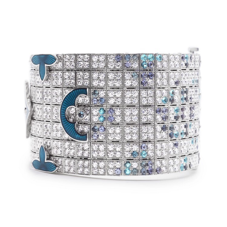 Close-up of the Louis Vuitton high jewelry bracelet, showcasing the vibrant Paraiba tourmalines and purple spinels on the Damier pattern section.