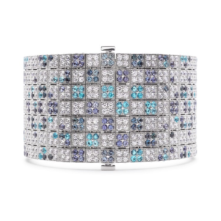Side view of the Louis Vuitton 'Voyage dans le temps' bracelet, illustrating the exquisite craftsmanship of the white gold links and gemstone arrangement.