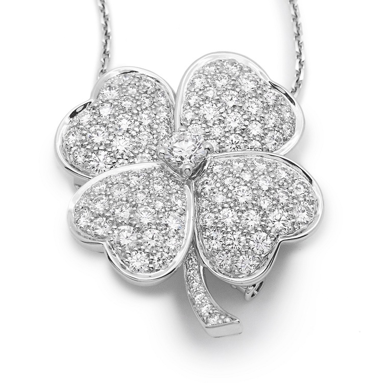 Angled view of the Van Cleef & Arpels Cosmos four-leaf clover pendant brooch, showcasing the intricate diamond setting and platinum craftsmanship.