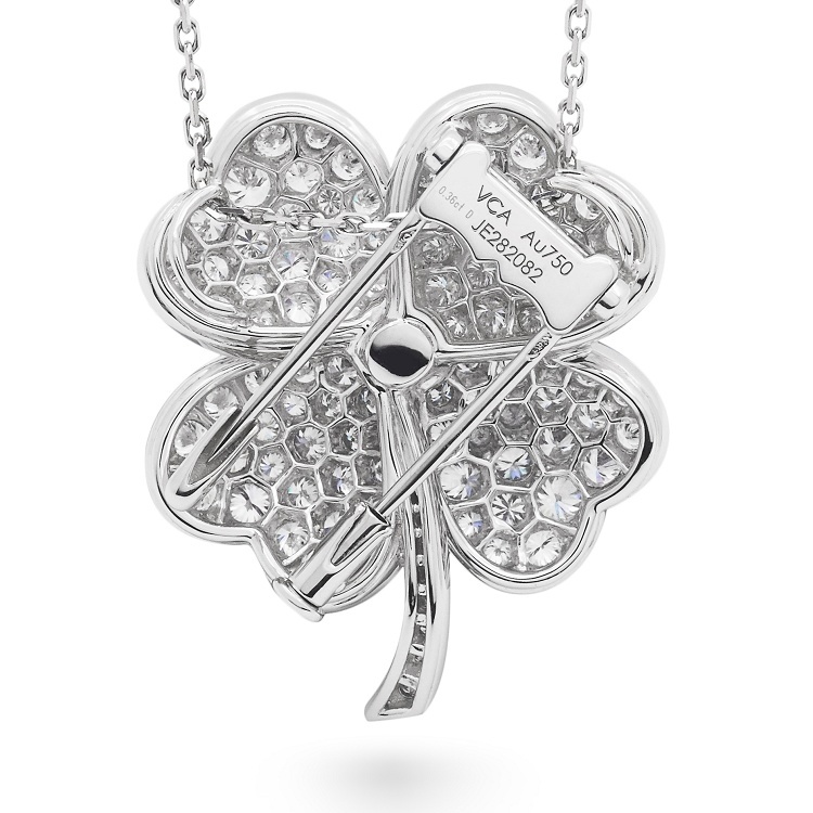 Close-up detail of the Van Cleef & Arpels Cosmos pendant brooch, highlighting the 'Snowflake Mosaic' diamond setting on the heart-shaped petals.
