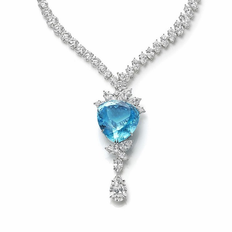 Detail shot of the Harry Winston Paraiba Tourmaline necklace, highlighting the intricate setting and the brilliant sparkle of its diamonds.