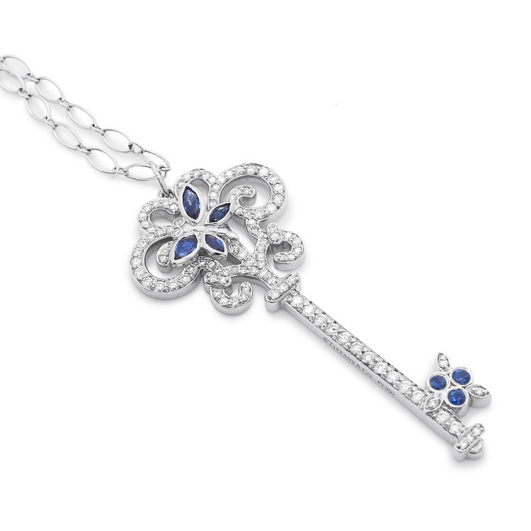Detailed view of the diamond-encrusted swirl pattern on the handle of a Tiffany key pendant