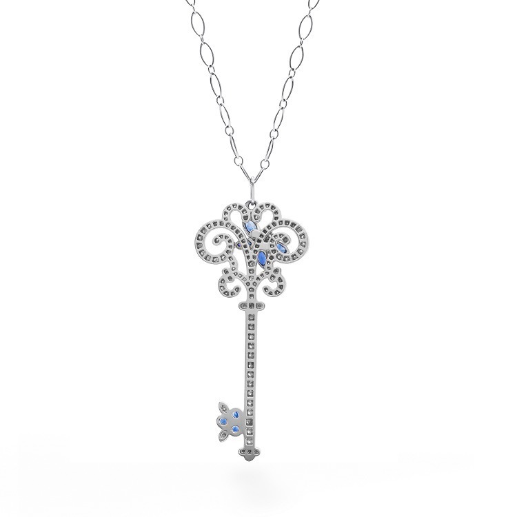 The unique fruit-shaped key bit adorned with sapphires on a Tiffany & Co. pendant