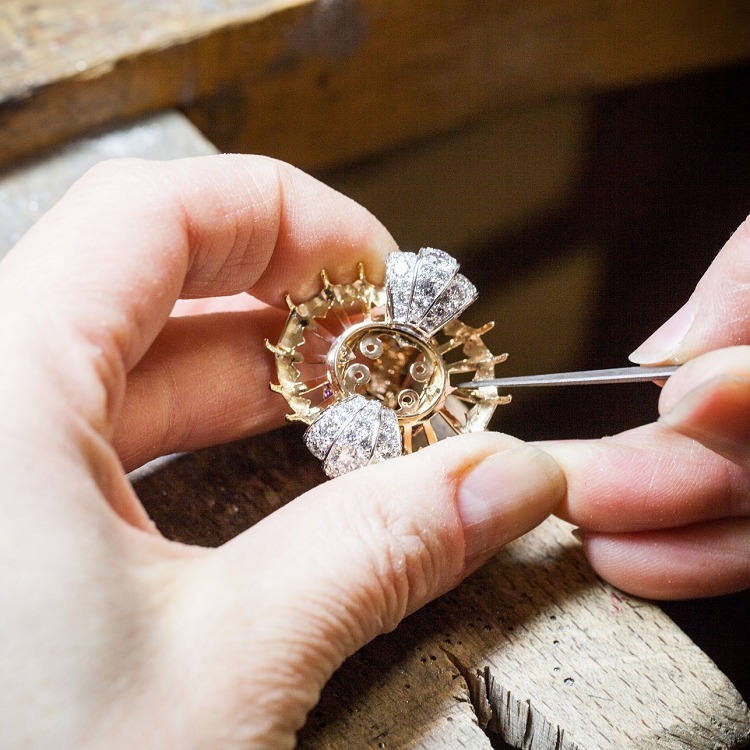 Detailed shot of the 'Summer Cocktail' ring by Van Cleef & Arpels, highlighting purple sapphires and coral petals