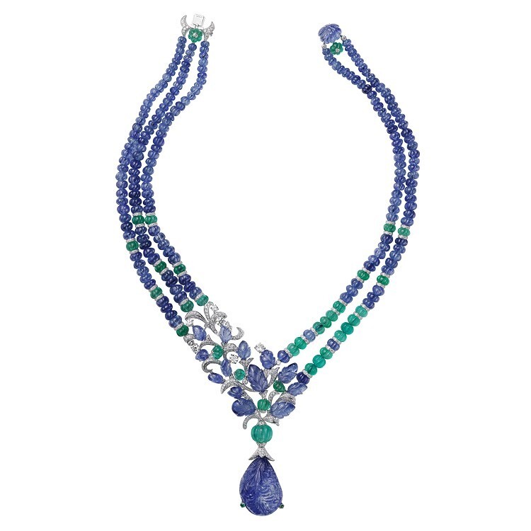 A stunning Cartier 'Fruit Tips' high jewelry necklace featuring a large carved sapphire pendant and sapphire and emerald beads, adorned with brilliant-cut diamonds.
